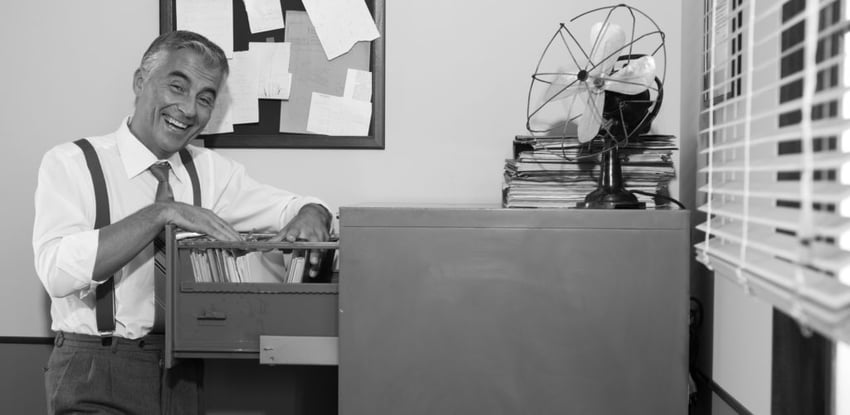 old office worker with vintage file cabinet